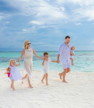 Happy family running at the beach